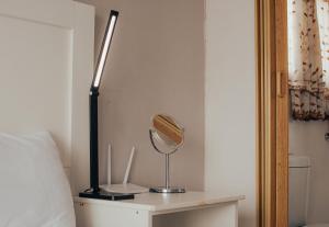 a mirror on a table next to a bed at Dreamers B&B in Maseru +1 photo