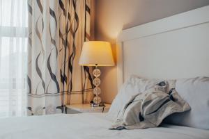 a bedroom with a bed with a lamp and a window at Dreamers B&B in Maseru