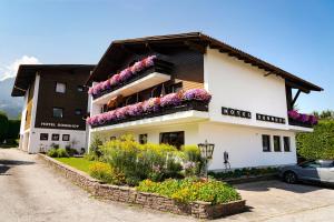 a building with flowers on the side of it at Hotel Sonnhof in Innsbruck