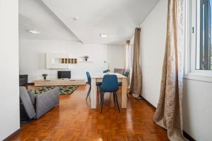 a living room with a table and chairs and a couch at Funchal Paradise in Funchal