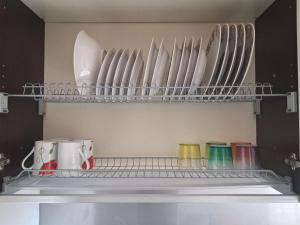 a shelf in a refrigerator with plates and cups at Maralis Portorosa in Furnari