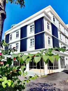 a large white building with blue stripes on it at 118 Grand Hotel in George Town