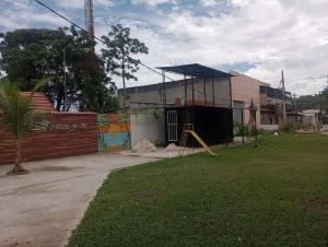 a yard with a playground and a building at Container Black in Pedra de Guaratiba