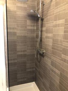 a bathroom with a shower with a glass door at Torwood House in Penzance +30 photos