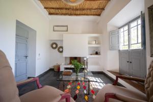 a living room with white walls and a wooden ceiling at Domaine Darsyada Boutique Hôtel Deluxe Et Spa in Marrakesh