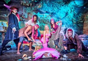 a group of people dressed in costumes in a stage at Camping Les Sables d'Or Pirates World - Aquatique Vacances in Le Grau-dʼAgde +12 photos