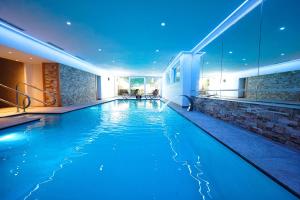 a swimming pool in a house with a lit up room at Hotel Sonnhof in Innsbruck