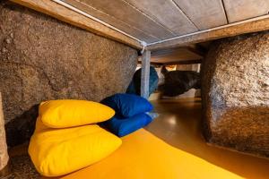 a couple of yellow and blue pillows in a cave at The Rock Samui Beach Resort in Lamai