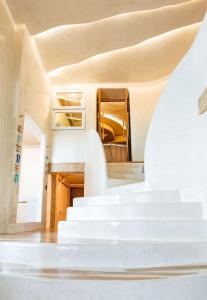 a staircase in a house with white stairs at The Rock Samui Beach Resort in Lamai