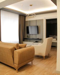 a living room with a couch and a chair at Viva Nova Suit Hotel in Bakanlıklar
