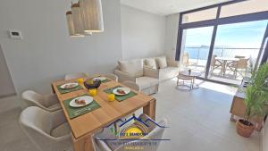 a living room with a table with plates of food on it at Nini Sunset Sailor Luxury Apartment in Benidorm