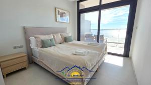 a bedroom with a bed with a view of the ocean at Nini Sunset Sailor Luxury Apartment in Benidorm +31 photos