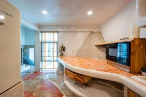 a kitchen with a large counter top in a room at The Rock Samui Beach Resort in Lamai