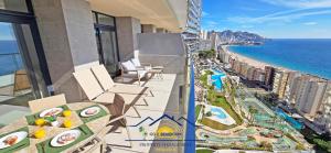 a balcony with a view of the beach and the ocean at Nini Sunset Sailor Luxury Apartment in Benidorm