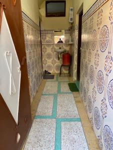 a bathroom with a sink and a tile floor at GUESTS Of TATA in Tatta