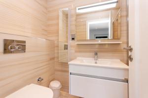a bathroom with a sink and a toilet and a mirror at Loch Earn in Inverness
