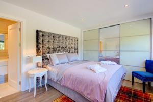 a bedroom with a bed and a table and a chair at Loch Earn in Inverness