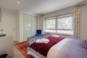 a bedroom with a large bed and a window at Loch Earn in Inverness