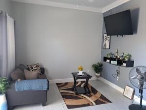 a living room with a couch and a table at Marie view Rentals in Abaco