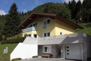 a house with a garage in front of it at Haus Wibmer in Kals am Großglockner