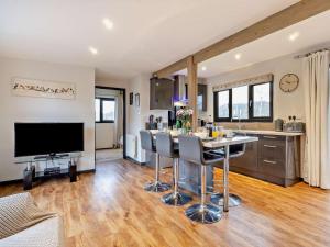 a kitchen and living room with a table and a television at 2 Bed in Norwich oc-73624 in East Harling