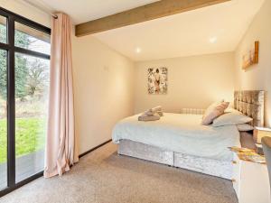 two beds in a bedroom with a window at 2 Bed in Norwich oc-73624 in East Harling