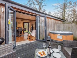 a house with a hot tub on a deck at 2 Bed in Norwich oc-73624 in East Harling