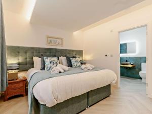 a bedroom with a large bed and a bathroom at 3 Bed in Newquay oc-90070 in Newquay