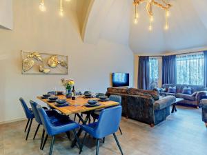 a living room with a table and blue chairs at 4 Bed in Newquay oc-90069 in Newquay