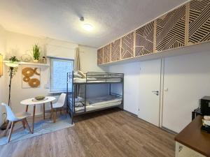a room with a bunk bed and a table at CityStay Montabaur in Montabaur