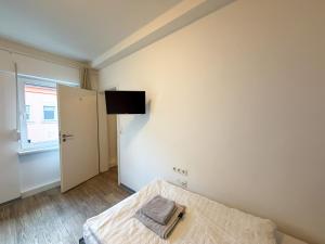 a bedroom with a bed and a television on the wall at CityStay Montabaur in Montabaur