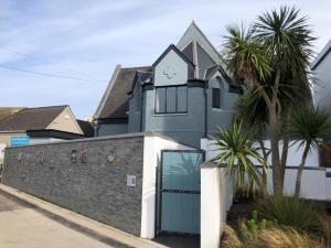 a house with a clock on the top of it at 4 Bed in Newquay oc-90069 in Newquay