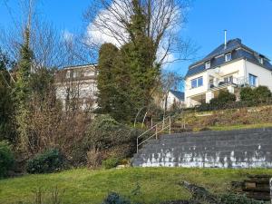 a white house on top of a hill at CityStay Montabaur in Montabaur