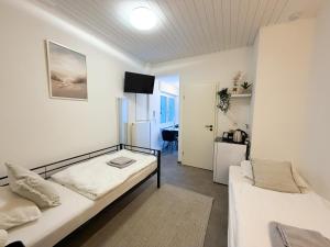 a small room with a bed and a couch at CityStay Montabaur in Montabaur