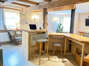 a kitchen with a desk with a laptop on it at Katzenbachlädle in Rottenburg