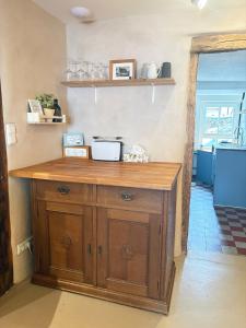 a wooden counter in a room with a kitchen at Katzenbachlädle in Rottenburg +5 photos