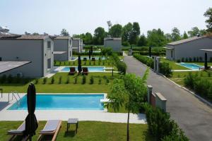 a view of a swimming pool in a yard at Ammos Luxury Pool Villas in Olympic Beach