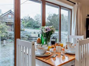 a dining room table with a view of a garden at 2 Bed in Norwich oc-64075 in East Harling