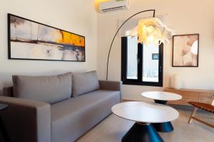 a living room with a couch and a table at Ammos Luxury Pool Villas in Olympic Beach