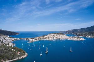 an aerial view of a harbor with boats in the water at Xenia Poros Image Hotel by GHH in Poros +118 photos