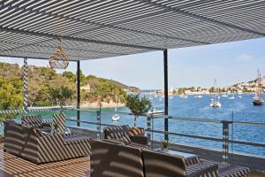 a deck with chairs and a view of the water at Xenia Poros Image Hotel by GHH in Poros