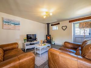 a living room with a couch and a tv at 2 Bed in Camelford oc-81245 in Camelford