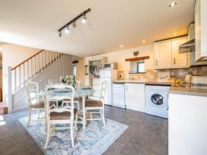 a kitchen with a table and chairs in a room at 2 Bed in Camelford oc-81245 in Camelford