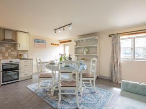 a kitchen with a table and chairs in a room at 2 Bed in Camelford oc-81245 in Camelford +15 photos