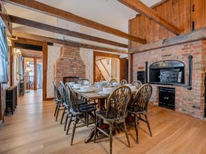 a dining room with a table and chairs and a brick fireplace at 4 Bed in Eastbourne oc-71297 in Eastbourne
