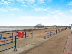 a row of blue rails next to the beach at 4 Bed in Eastbourne oc-71297 in Eastbourne