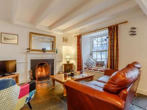 a living room with a couch and a fireplace at 2 Bed in Fowey oc-76624 in Fowey