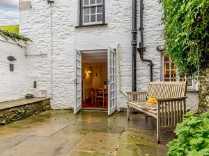 a patio with two chairs and a table in front of a building at 2 Bed in Fowey oc-76624 in Fowey