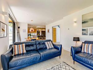 a living room with two blue leather couches at 4 Bed in Bude oc-83619 in Stratton