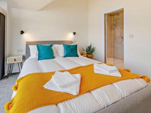 a bedroom with a large bed with towels on it at 4 Bed in Bude oc-83619 in Stratton +26 photos